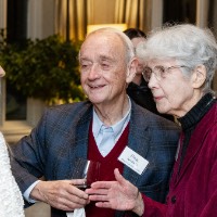 Doug Kindschi speaking with two women